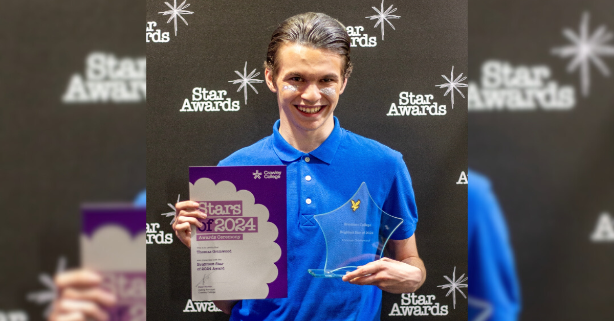 Thomas Grimwood holding his Star award and certificate