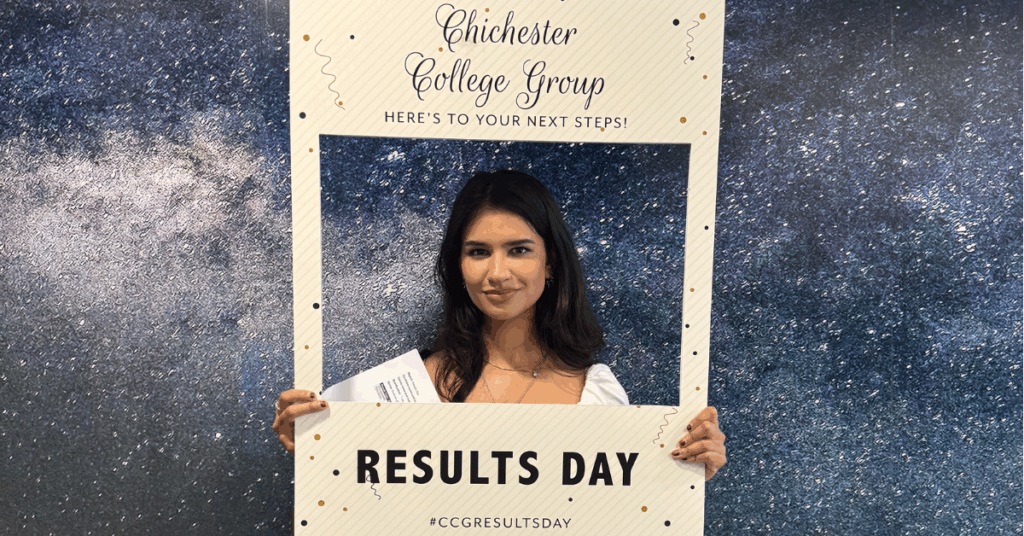 One of our students who received their results holding a photo frame