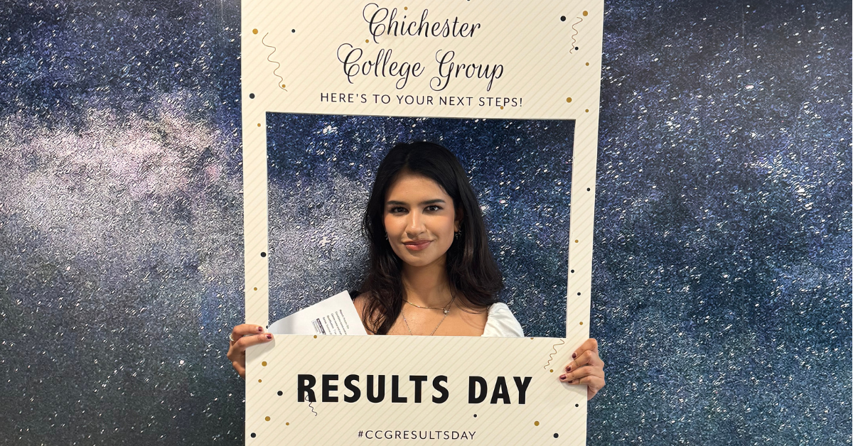 One of our students who received their results holding a photo frame